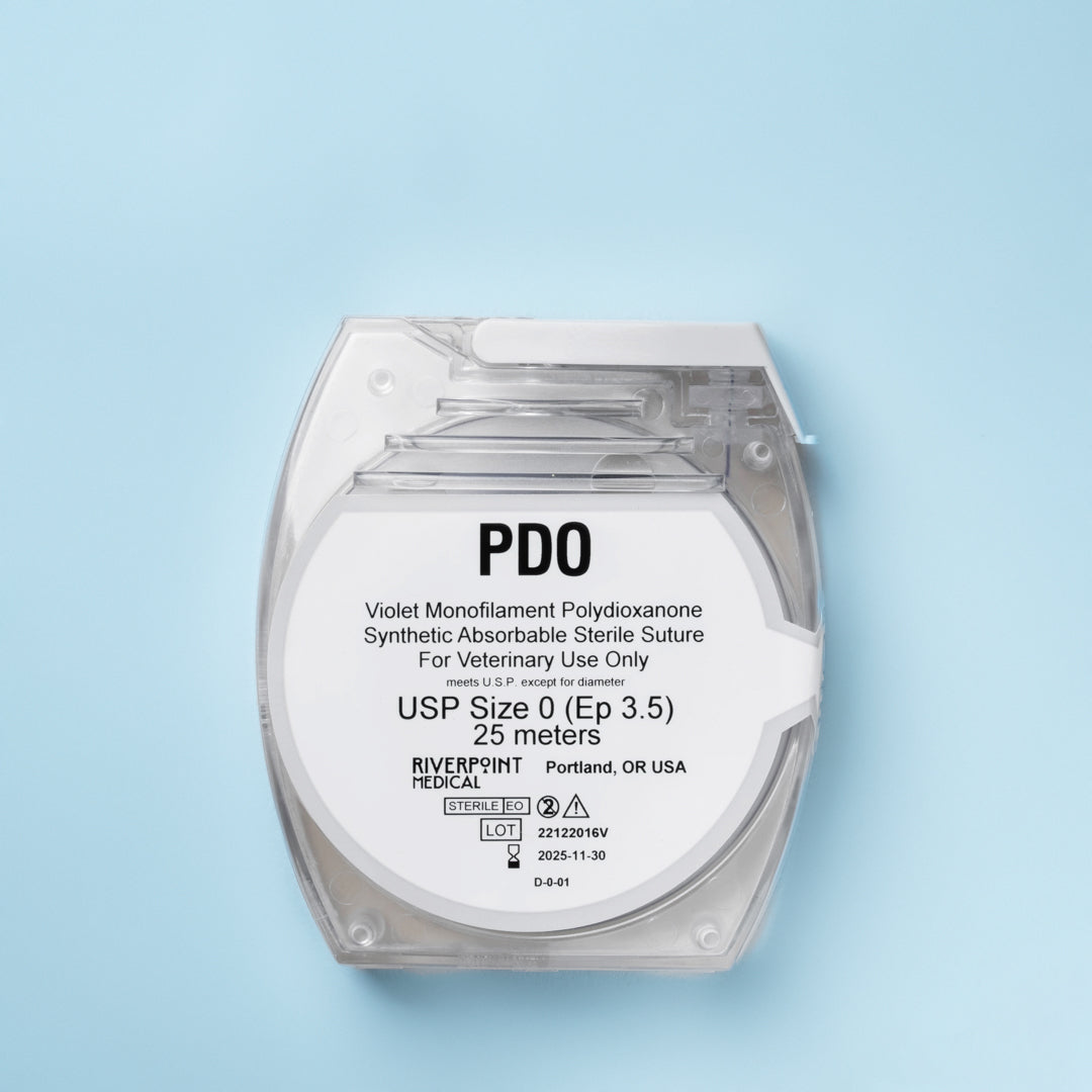 A clear package of PDO suture size 0 (Ep 3.5), showing a 25m violet monofilament thread made of polydioxanone for veterinary use. The label emphasizes its absorbable nature, extended wound support of 6 weeks, and compliance with USP &amp; EP standards. Manufactured by RIVERPOINT in Portland, OR, USA, highlighting its premium quality and suitability for various surgical applications.
